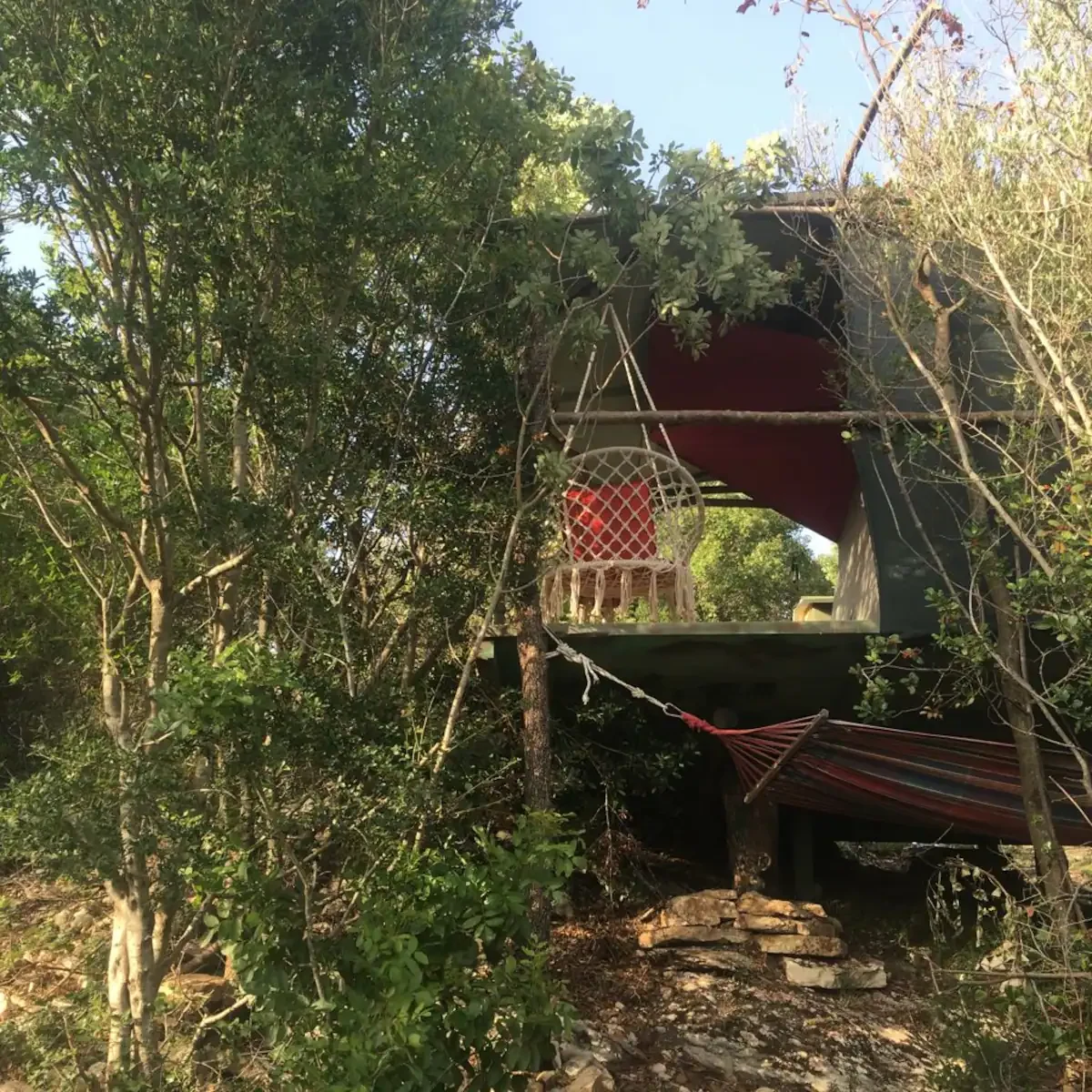 La tenda e la terrazza rialzata tra gli alberi